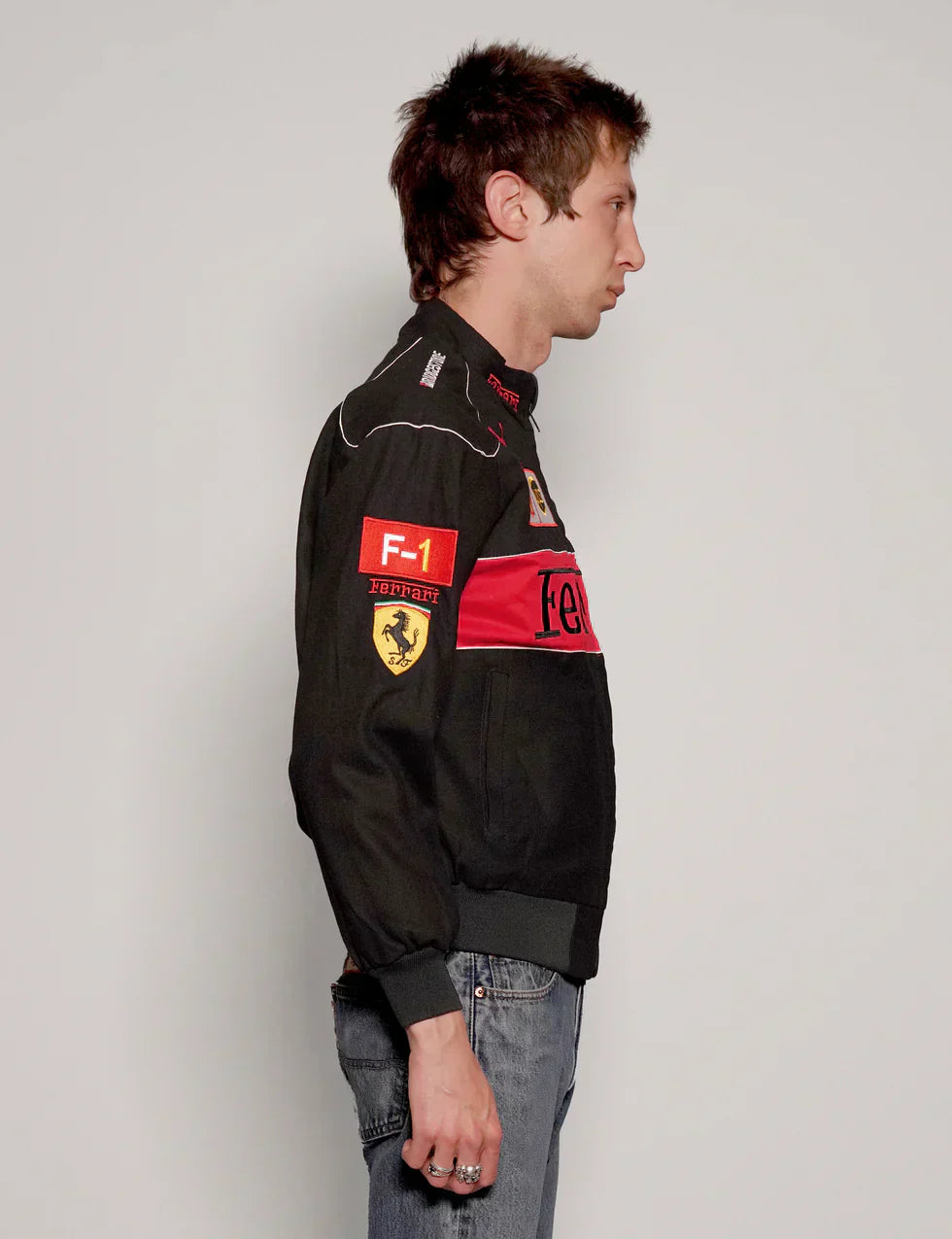 Male model styling the vintage f1 inspired black ferrari jacket