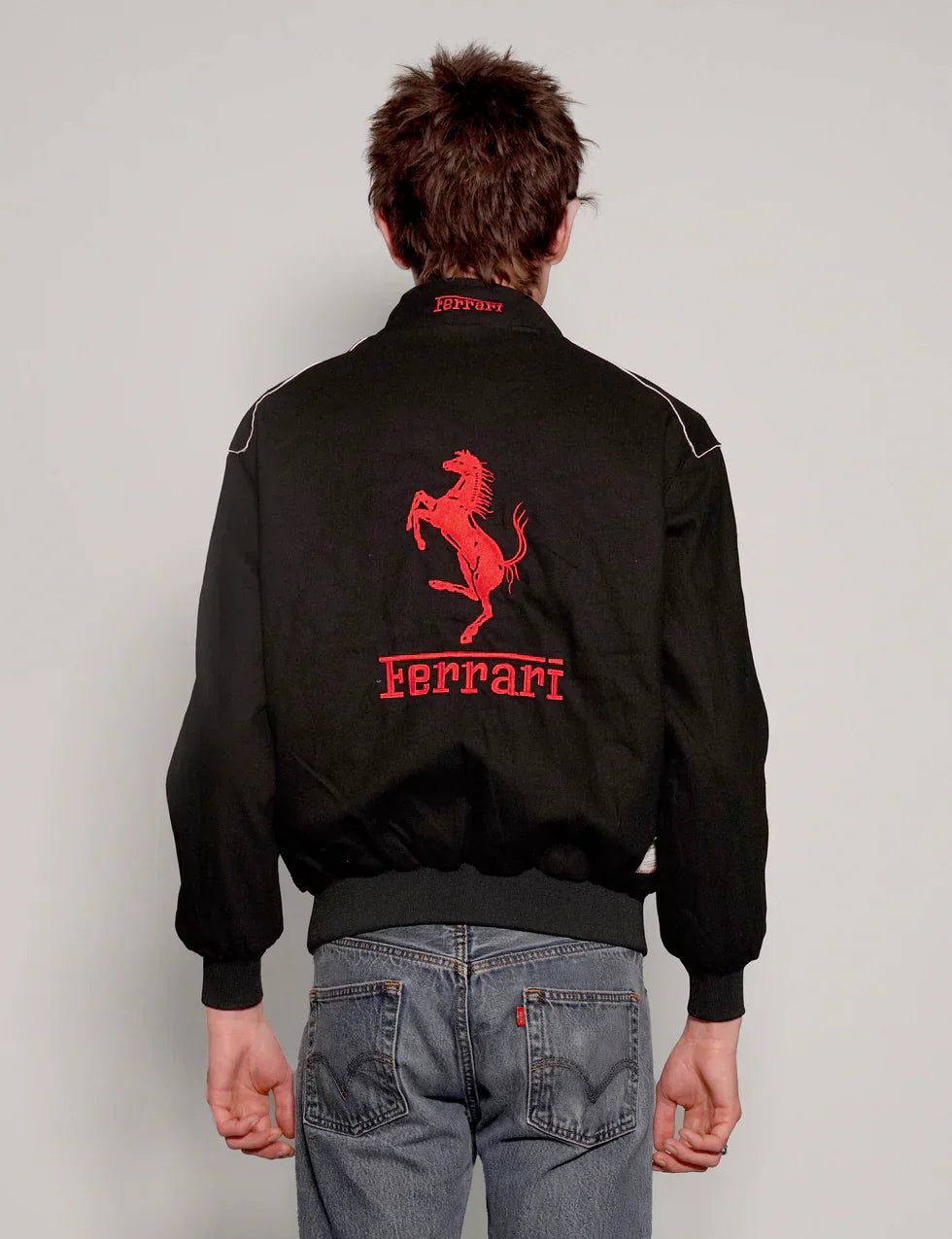 Back design showing the structured drape of the oversized y2k black ferrari jacket