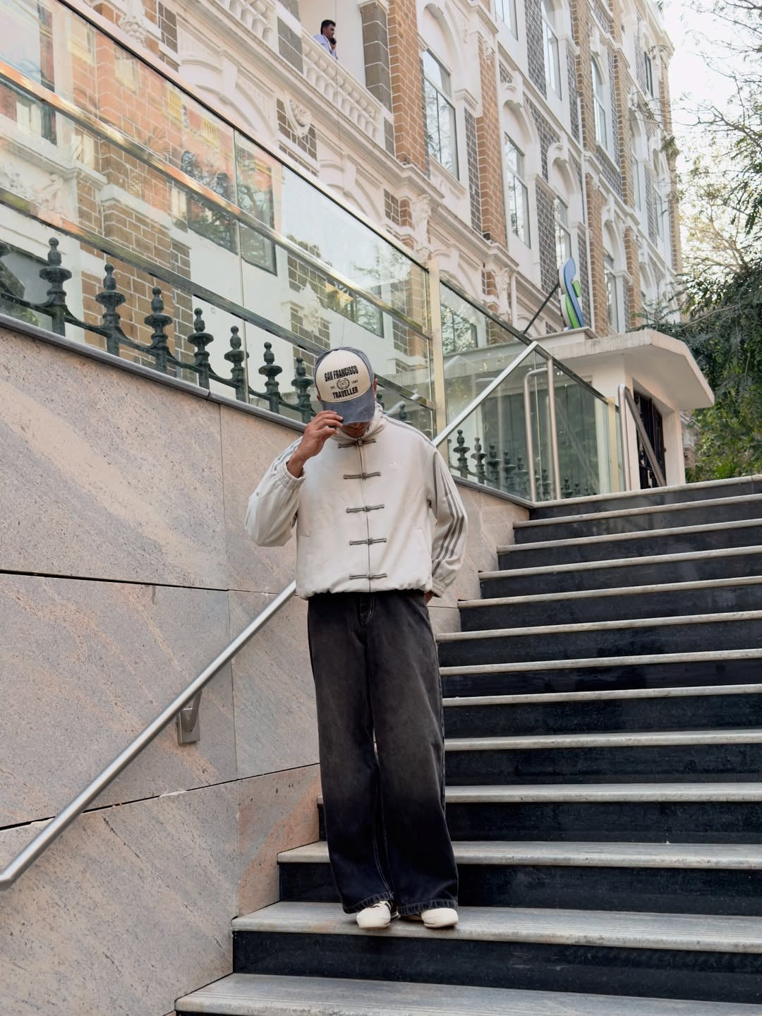 Indian man styling the crisp White Chinese New Year Jacket by Northly with dark trousers for a modern urban outfit