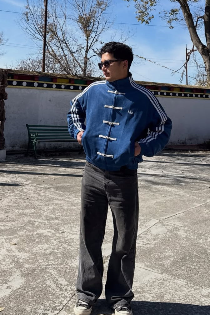 Male model styling the trendy y2k men's navy blue cny streetwear jacket with baggy streetwear denim