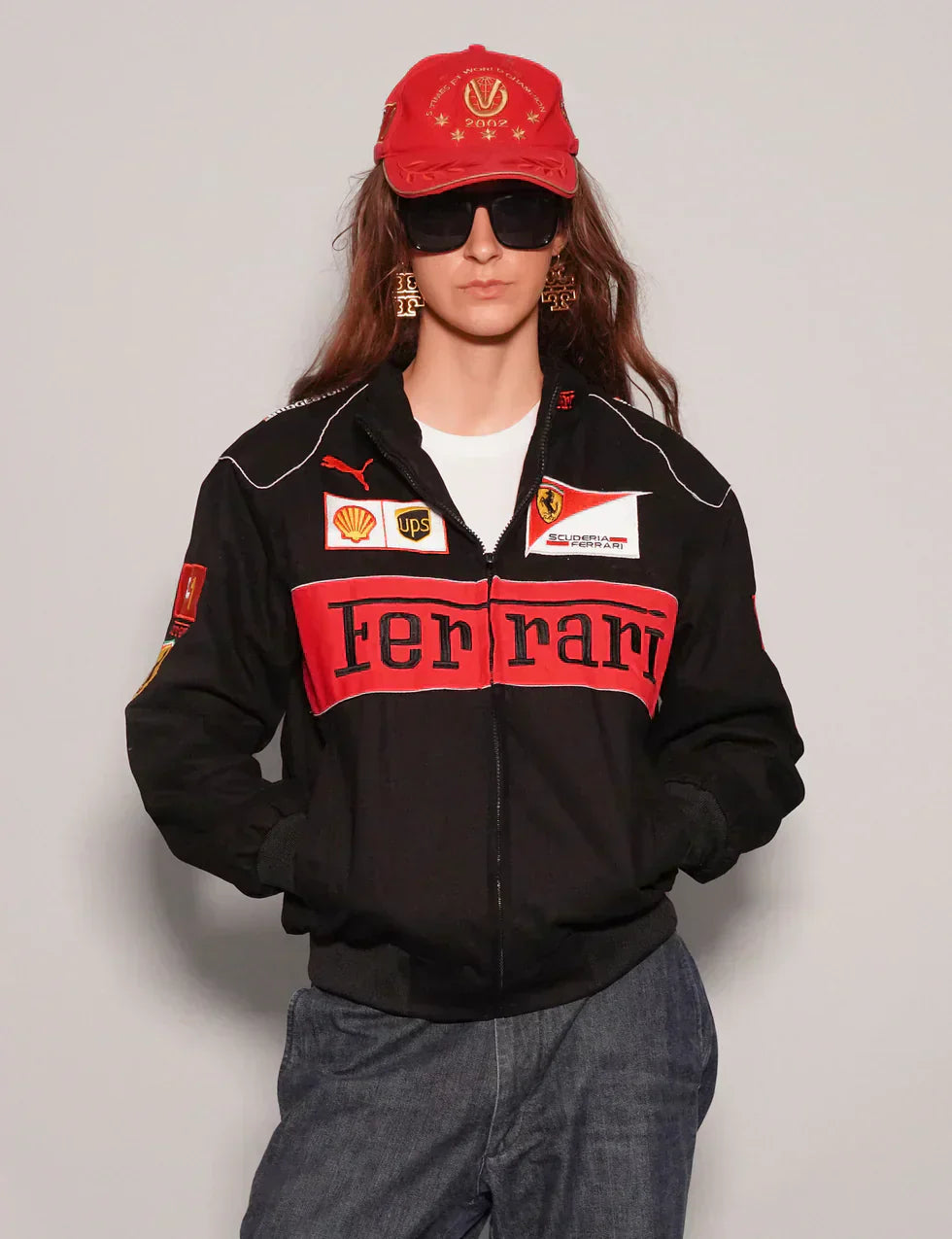 Person wearing a Women Black Ferrari Racing Jacket with red accents on a plain background