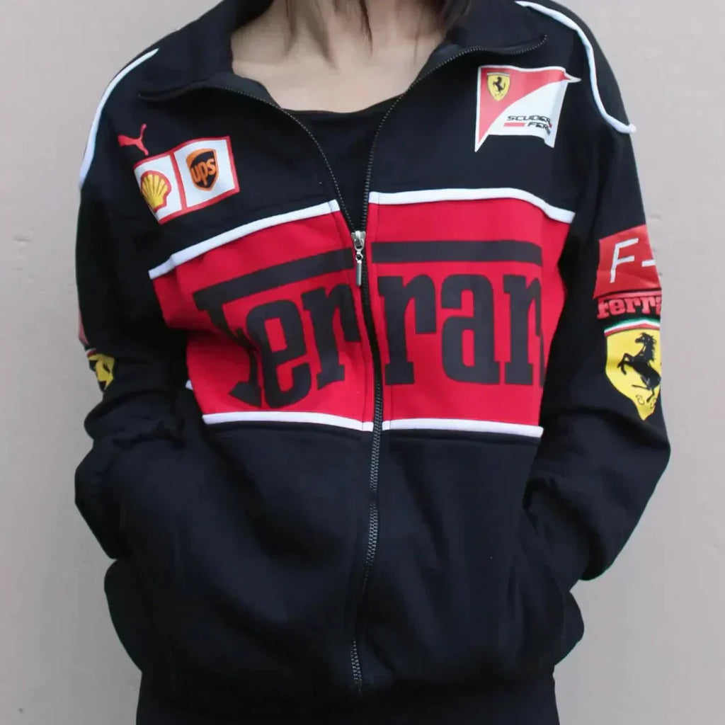 Black, red, and white Ferrari tracksuit jacket with various logos on a plain background