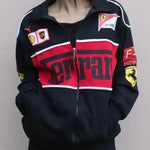 Black, red, and white Ferrari tracksuit jacket with various logos on a plain background