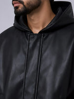 Close-up of a person wearing a black leather jacket with a hood.